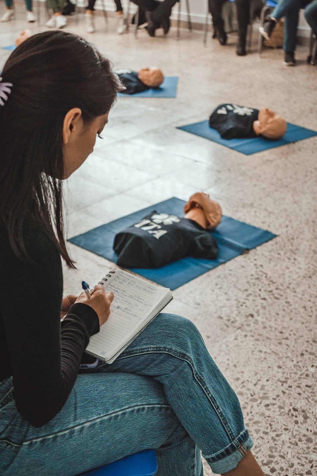 Alumna tomando notas en curso